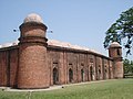 Image 27alt=Building of red bricks with a roof consisting of many white domes. There are small round towers on the corners of the building each crowned by a white cupola. (from Culture of Bangladesh)