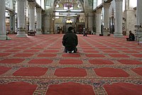 A man prays in the mosque in 2008