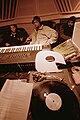 Image 15Hip hop producer and rapper RZA in a music studio with two collaborators. Pictured in the foreground is a synthesizer keyboard and a number of vinyl records; both of these items are key tools that producers and DJs use to create hip hop beats. (from Hip hop production)