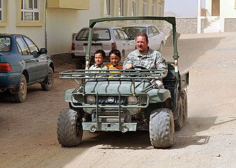 Two Hazara children and a US soldier in Jaghori