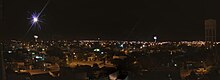 A panoramic picture of General Roca at night where fireworks can be seen.