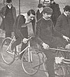 Male cyclist on a bicycle in a crowd of pedestrians