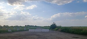 Russian anti-tank defense line in Zaporizhzhia Oblast with chained together dragon teeth and a concrete road block