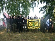 Young men, faces blurred, with a banner and flag