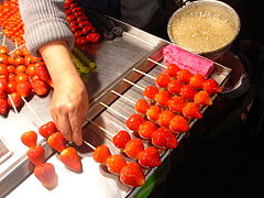 Strawberry dipped with sugar coating for sale as a bintang hulu (2004)