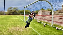 CFHS boys soccer goalie stopping a goal