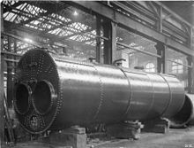 Lancashire boiler 1900, painted with a protective coating, the mountings such as safety valves, stop valve, feed check valves and water level gauges, have been removed.[118]