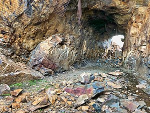 2018 photograph of Needle's Eye Tunnel, near the summit of Rollins Pass. This view shows the northeast portal in the foreground; the southwest portal can be seen in the background. Wire mesh and metal dowels were installed in August 1987 to help reduce additional rock falls and preserve the condition of the tunnel constructed in 1903 (121 years ago) (1903).