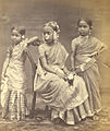 Image 9A Tamil Hindu girl (center) in 1870 wearing a half-saree, flowers and jewelry from her Ritu Kala samskara rite of passage (from Samskara (rite of passage))