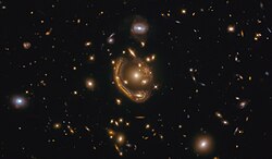 Dubbed the "Molten Ring", Hubble sees strong lensing around GAL-CLUS-022058s.[10]