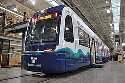 Exterior view of a train parked in a garage.