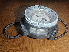 Diving compass in aftermarket wrist mount with bungee straps