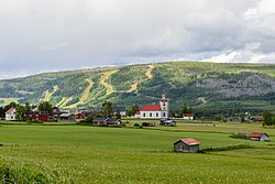 June 2014 view of Klövsjö with Klövsjö Church and the skiing hills seen in the background