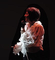 Color photograph of a woman singing