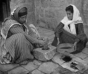 1905 Stereoscope. Original caption reads: The native mode of grinding coffee, Palestine.
