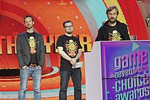 Three men onstage at Game of the Year awards