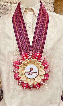 Pink rosette leis worn by Vice President Leni Robredo during a campaign rally in Pampanga, Philippines