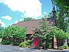 Side elevation of St. James Episcopal Church, showing red entrance doors dedicated to Lisette Denison Forth