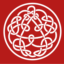 A knotwork, a design often associated with Celtic knots. The outer design is a a circle, surrounding what appears to be a triangle surrounded by a Celtic knot at first glance. Closer inspection of the triangle reveals that it is in fact an organic part of the inner knot, which seems to have two continuous segments linked by knots. At first glance, the knotwork appears to be symmetric; closer inspection reveals that the right-hand knots seem to be the reverse of the left-hand knots and there are are small differences among the "twin knots"; the right and left hands of the design have variations, much as our right and left hands have subtle distinctions. The design is not symmetric with respect to 120 degree rotations: The center of the pseudo-triangle is above the center of the surrounding circle, but visual balance is maintained by extra knots below the lower pseudo–line-segment. The background is crimson.
