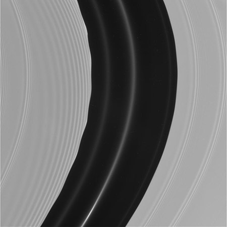 Pan's motion through the A ring's Encke Gap induces edge waves and (non-self-propagating) spiraling wakes[173] ahead of and inward of it. The other more tightly wound bands are spiral density waves.