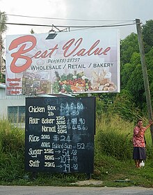 A hand-painted sign with several grocery items, their prices, and weights