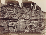 Black-and-white photograph of a wall made of various random antiquities.