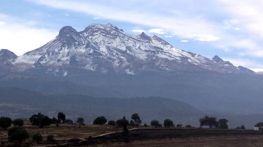 The summit of Volcán Iztaccíhuatl, a stratovolcano on the border between Puebla and México State, is the third highest peak of Mexico.