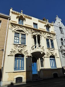 Mix of Art Nouveau and Gothic Revival – Rue Gustave-Lemaire no. 51 in Dunkerque, France, with pointed arched-dormer windows and balcony loggia, unknown architect, decorated with sculptures by Maurice Ringot (1903–1910)[176]