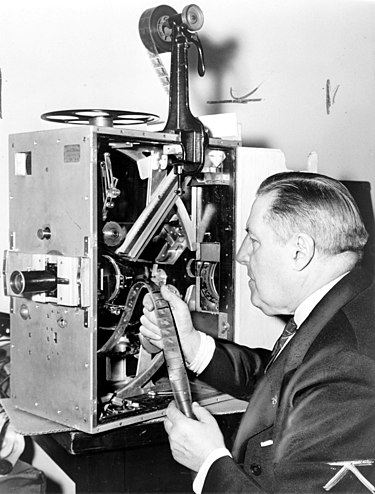 Cinematographer Billy Bitzer with movie projector