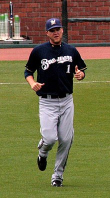 A baseball player in navy and gray