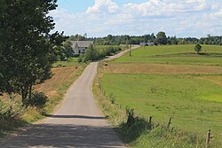 A paved road in the village of Grzybina leading to Lithuania