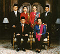 Image 42Formal family portrait of former Indonesian's President B.J. Habibie. Women wear kain batik and kebaya with selendang (sash), while men wear jas and dasi (western suit with tie) with peci cap. (from Culture of Indonesia)