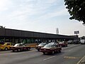 Picture of the station in the middle of Río Consolado Avenue. Several automobiles surround the station.