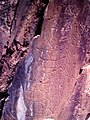 Paleolithic rock engravings breaking the natural rock formation