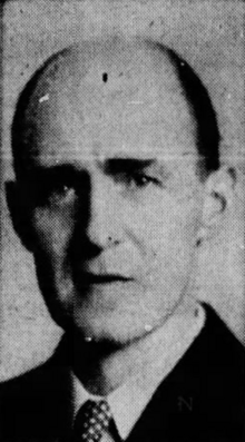 Black-and-white newspaper photograph of Horton Davies. This portrait focuses on the face. Davies is male, balding, Caucasian, and faces the camera with a neutral expression. He wears a dark suit jacket, a white collared shirt, and a polkadot necktie.