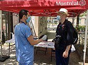 A healthcare worker speaking to a patient at a mobile testing clinic in Montreal