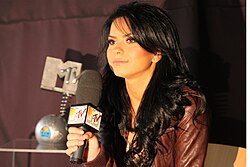 A photograph of Inna with a microphone in her hand