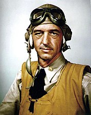 A US Navy pilot during World War II wearing an orange inflatable life jacket.