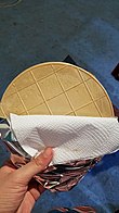 large, thin wafer held in a hand