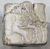 Fighting scene between a beast and a man with horns, hooves and a tail, who has been compared to the Mesopotamian bull-man Enkidu.[8][16][10] Indus Valley civilization seal.