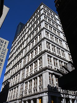 The white granite facade of 195 Broadway as seen from the corner of Fulton Street and Broadway