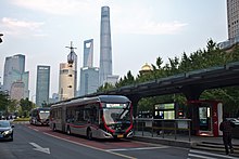 Two buses at a bus stop in Shanghai, China