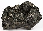 Vug filled with clusters of sprays of lightly iridescent, metallic-lustre semseyite blades on sphalerite matrix