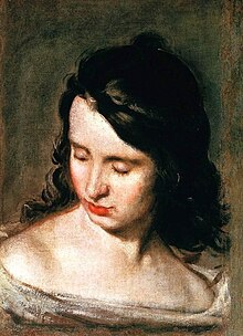 Portrait of a brown haired woman looking down with her eyes closed, portraying her blindness.