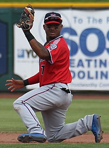 A baseball player in red and gray
