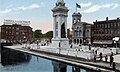 The monument (with original plaza) and Erie Canal in a 1917 postcard.