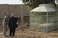 A U.S. soldier and the shrine's caretaker discussing about the condition of a grave in the cemetery