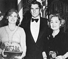 Isabella Karle, John Warner, and Marguerite Chang pose for a photo. Both women are holding awards. Karl is a white woman, smiling; Warner is a white man in a tuxedo; Chang is a Chinese woman with grey hair, smiling.