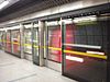 A train passes through a station protected by platform screen doors