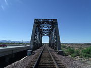 The historic "Agua Fria River Bridge” was built over the Agua Fria River by the Santa Fe Railroad in 1895. It is located on the right side of Grand Ave. if traveled from Phoenix to Wickenburg, close to 111 Ave. in El Mirage, Az.